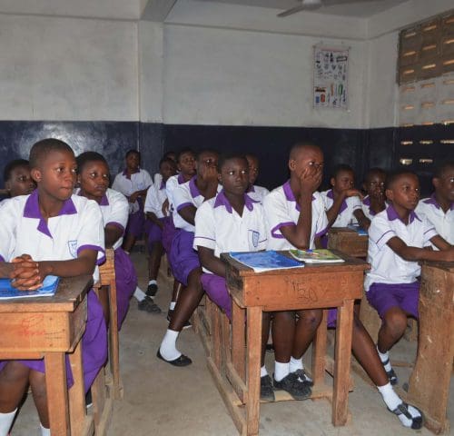 Schoolgirls sitting at desks in classroom