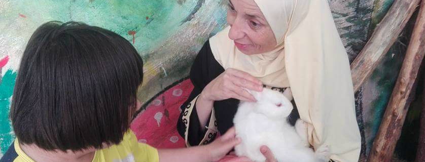 Women holding white rabbit