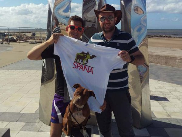 SPANA fundraisers holding up SPANA tshirt with dog
